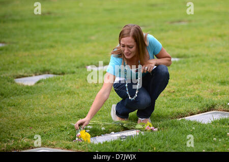 May 08, 2013 - Riverside, California, U.S. - An unidentified woman places flowers and grieves at the headstone of murder victim Travis Alexander at Olivewood Cemetery in Riverside, on Tuesday, May 8, 2013 the day Travis's ex-girlfriend Jodi Arias received a 1st degree murder verdict for his death. Arias was convicted of stabbing and shooting to death Travis Alexander, 30, in his suburban Phoenix home in June 2008. (Credit Image: © Steven K. Doi/ZUMAPRESS.com) Stock Photo