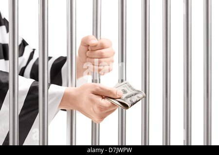 Man in jail holding prison bars and giving bribe isolated on white background Stock Photo