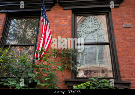 American flag displayed on an 1827 house on Mulberry Street in NYC Stock Photo
