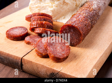 Domestic Serbian sausage and cheese in background Stock Photo