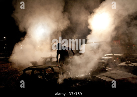 A driver evacuates his disabled vehicle during a demolition derby in southern Ohio. Stock Photo