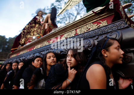 Women dressed with traditional clothing carry a throne during Semana Santa in La Antigua Guatemala, March 27, 2013. Stock Photo