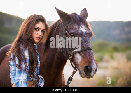 USA, Texas, Cowgirl standing with horse Stock Photo