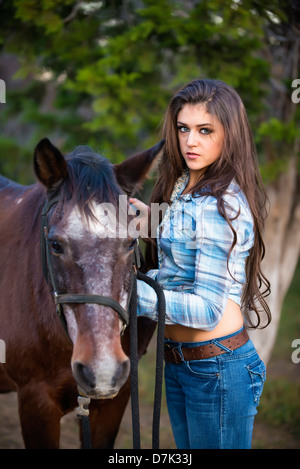 USA, Texas, Cowgirl standing with horse Stock Photo