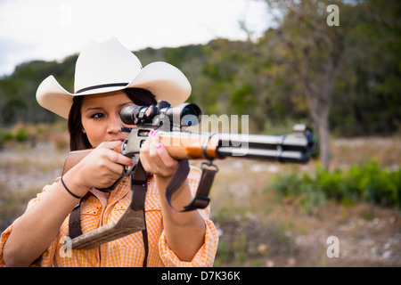 USA, Texas, Young woman with hunting rifle Stock Photo