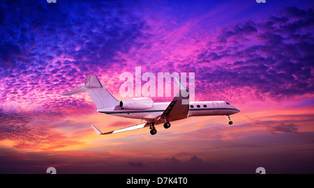 Private jet maneuvering in a spectacular sunset sky Stock Photo