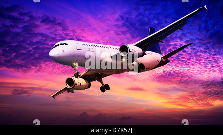 Jet is maneuvering in spectacular sunset sky Stock Photo