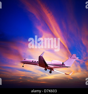 Private jet maneuvering in a spectacular sunset sky. Square composition. Stock Photo