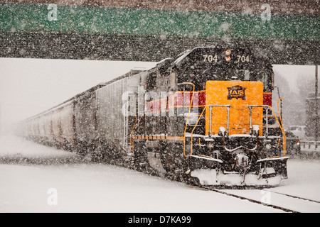 An IAIS locomotive moves through Moline, IL during a blizzard. Stock Photo