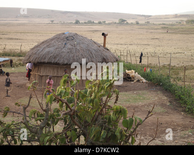 Masai children at thatched hut in Serengeti Stock Photo