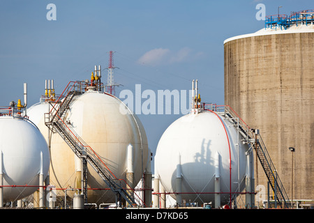 Liquid gas storage tanks in a refinery during daytime. Stock Photo