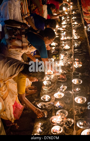 Hindu devotees light ghee lamps at a shrine near the Arunachaleswara Temple in Tiruvannamalai, Tamil Nadu, India Stock Photo