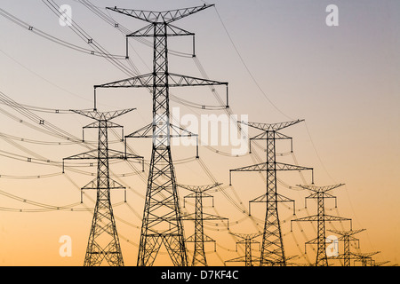 Power Transmission towers and lines against a sunset sky. Stock Photo