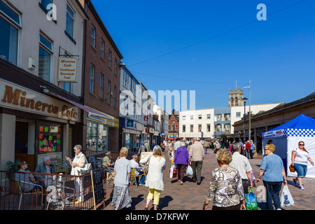 Cafe and shops on the Market Place with spire of St George's Minster in the distance, Doncaster, South Yorkshire, England, UK Stock Photo