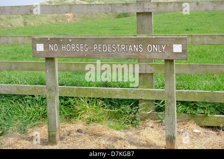A notice by a path to the beach No Horses, Pedestrians Only Stock Photo