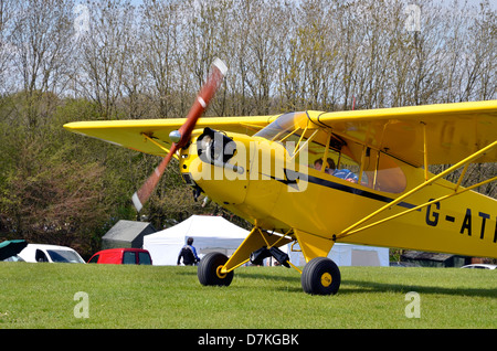 Piper J-3 Cub - a small, simple, light aircraft built between 1937 and 1947 by Piper Aircraft. In standard 'cub yellow'. Stock Photo