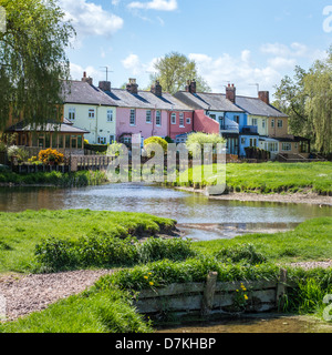 A row of colourful painted terraced houses overlook the river Stour and common-lane in Sudbury, Suffolk, England. Stock Photo