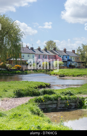 A row of colourful painted terraced houses overlook the river Stour and common-lane in Sudbury, Suffolk, England. Stock Photo