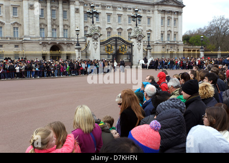 Changing of the Guard at Buckingham Palace : the tourists are waiting for the infantry parade. Stock Photo