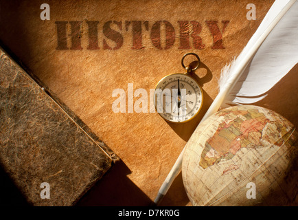History etched on an old paper scroll with a feather quill and compass Stock Photo
