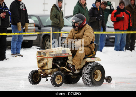 A man races a lawn mower during ice races on Knife Lake on February 9, 2013 in Mora, Minnesota. Stock Photo