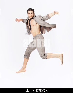 Handsome jumping guy on suit isolated on a white background Stock Photo