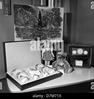 Presents for the family of US president John F. Kennedy who visited Berlin on 26 June 1963. A doll for Caroline, a teddy bear for John John, porcelain, a clock showing world time and some paintings showing parts of Berlin. Stock Photo
