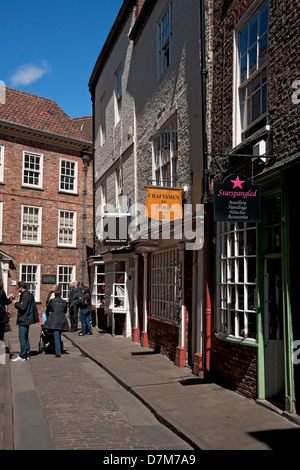 People visitors tourists walking along The Shambles in spring York North Yorkshire England UK United Kingdom GB Great Britain Stock Photo