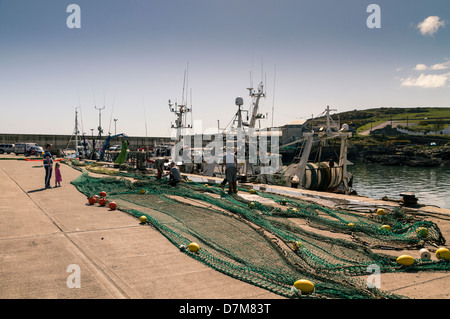 Nets being mended and prepared prior to fishing trip Stock Photo