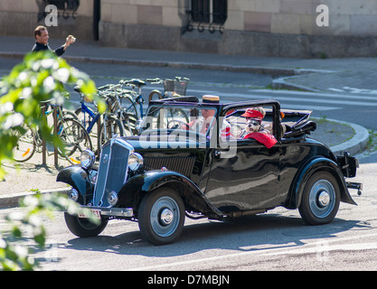 Elderly couple driving a 1935 convertible Mathis TY French vintage car France Europe Stock Photo