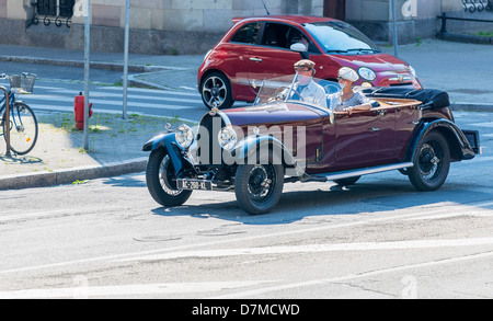Couple driving a convertible Bugatti French vintage car Stock Photo