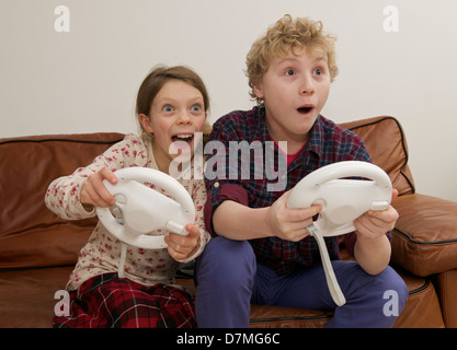 Boy and Girl Playing on Interactive Game in Home Setting Stock Photo