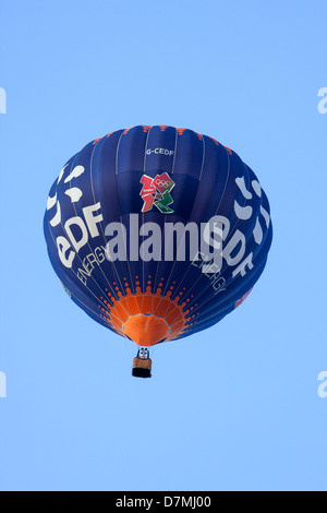Bath, United Kingdom- August 27, 2010: An hot air balloon, sponsored by EDF Energy, in flight against a clear blue sky. Stock Photo