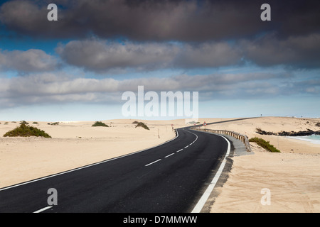 Road through sand dunes, Canary Islands Stock Photo
