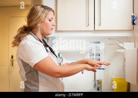 Nurse washing her hands Stock Photo