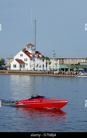 New York, Lake Ontario, Rochester. Rochester harbor with the red and white US Coast Guard station in the distance. Stock Photo