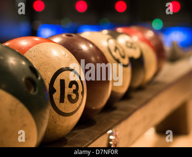 Retro style bowling balls racked and ready to play at the Goodnight bowling Alley in Austin, Texas Stock Photo
