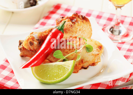 Roasted chicken drumsticks with lime and pepper Stock Photo