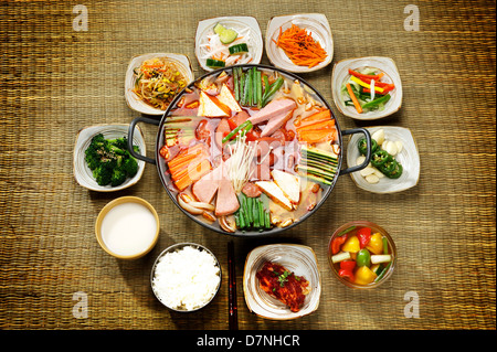 Korean signature Kimchi Stew in a hot ceramic pot served with other side  dishes Stock Photo - Alamy