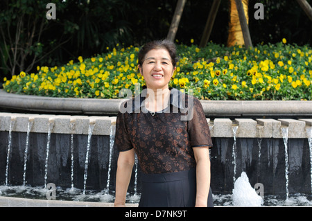 chinese middle aged woman in park Stock Photo