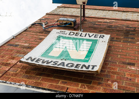 Dilapidated newsagent sign advertising home delivery. Conceptual image suggesting changing media  to non-paper alternatives Stock Photo