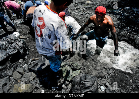 Miners Washing Miners wash the emerald containing mud in the mine of Muzo, Colombia ...