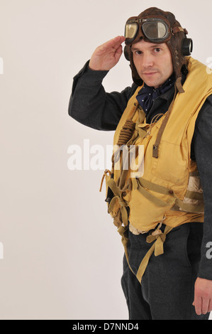 WW2 RAF pilot/crew member wearing flying helmet & 'Mae West' life jacket and saluting. Stock Photo