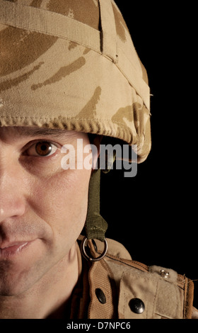 Half face portrait of a British soldier wearing desert camouflage uniform. Stock Photo