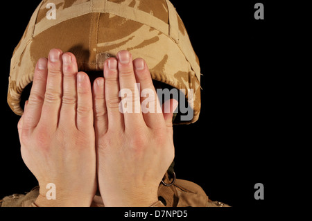 Soldier with hands covering his face. Soldier is wearing British ...
