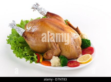 Eatable whole roasted chicken served with vegetable Stock Photo