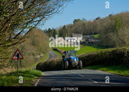 Tractor on the A5074 road through the Lyth Valley, South Lakeland, Cumbria, England UK Stock Photo