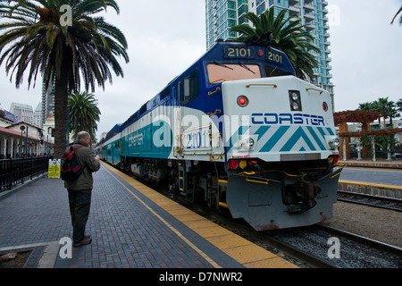 A train spotter watching the 'Coaster' come into San Diego station/depot. Stock Photo