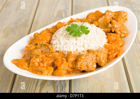 Lamb and sweet potato peanut stew served with white rice. Caribbean and West African dish. Stock Photo