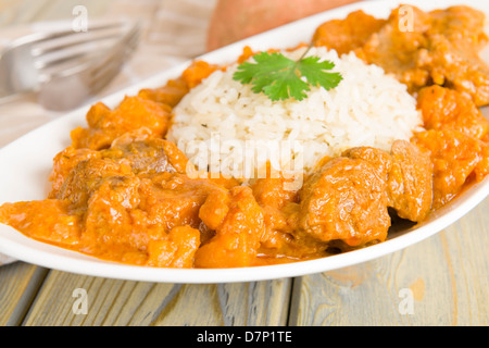 Lamb and sweet potato peanut stew served with white rice. Caribbean and West African dish. Stock Photo